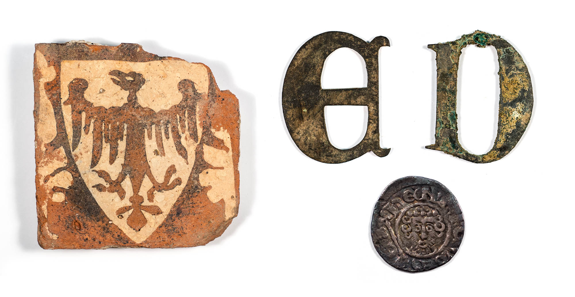 A selection of artefacts found during the excavation of the Grey Friars church: inlaid floor tile, tomb lettering and a coin - See artefacts like this at Leicester Guildhall