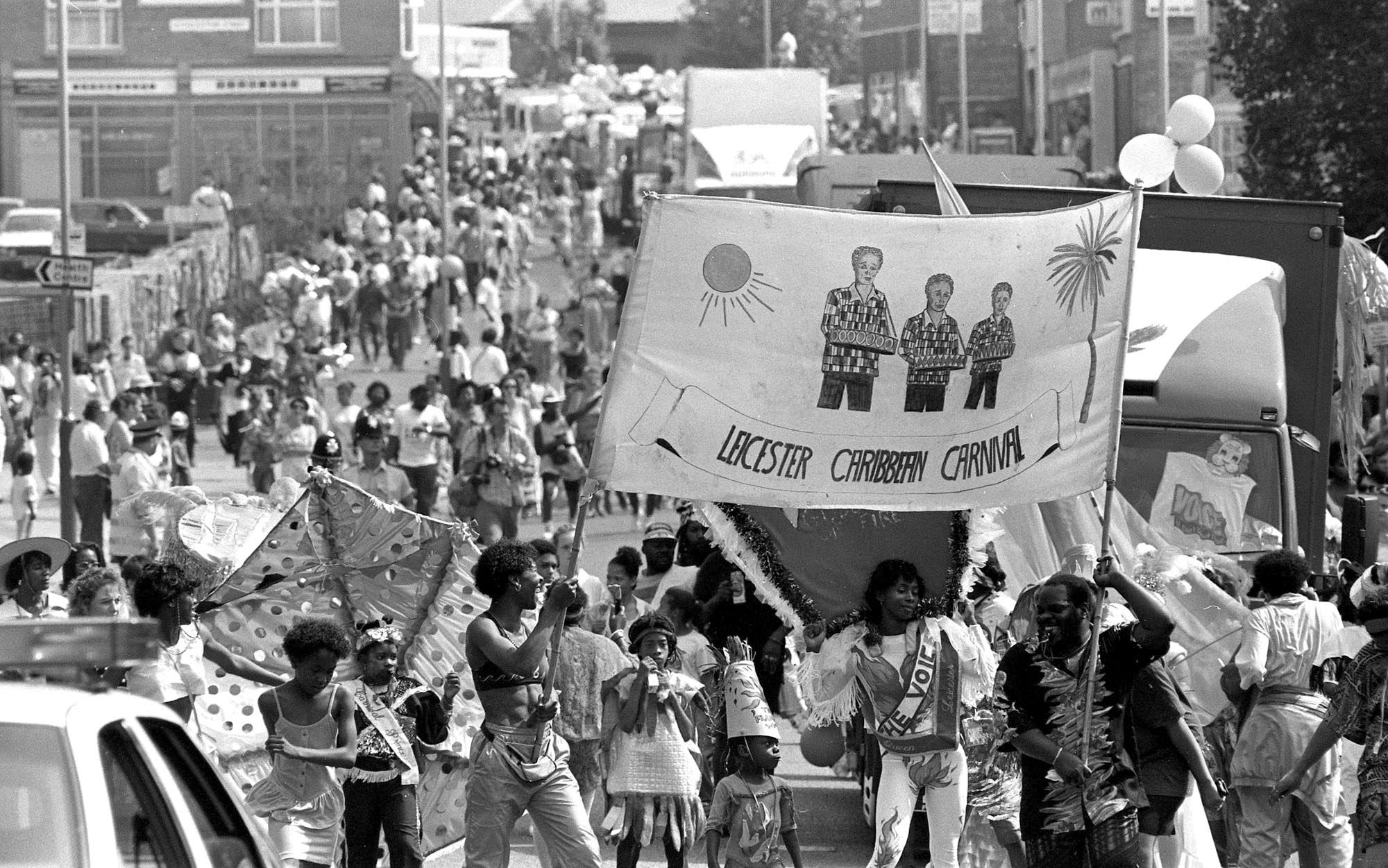 The Carnival parade makes its way along Sparkenhoe Street in front of large crowds, 1990 -