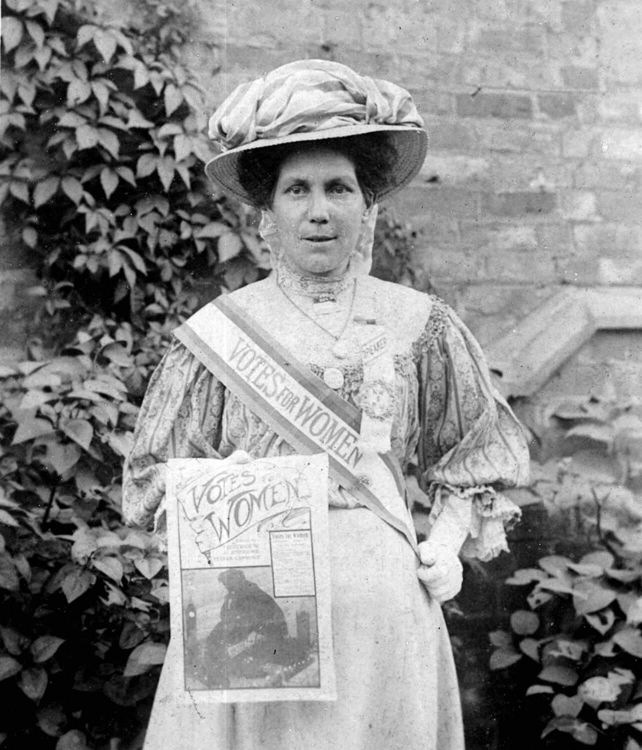 A portrait of Alice Hawkins wearing her suffrage sash and rosette - Peter Barratt