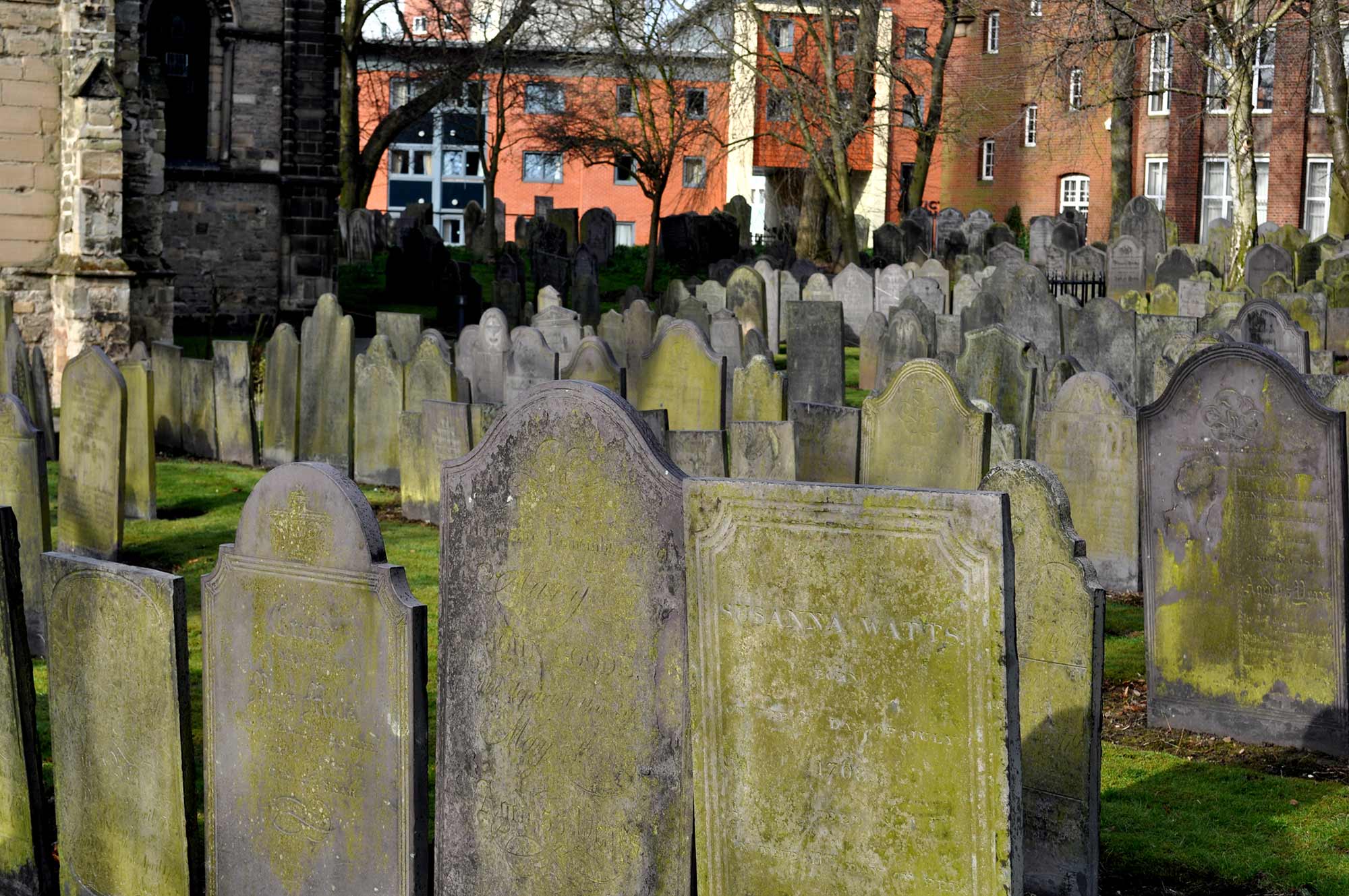 The churchyard houses many old gravestones -