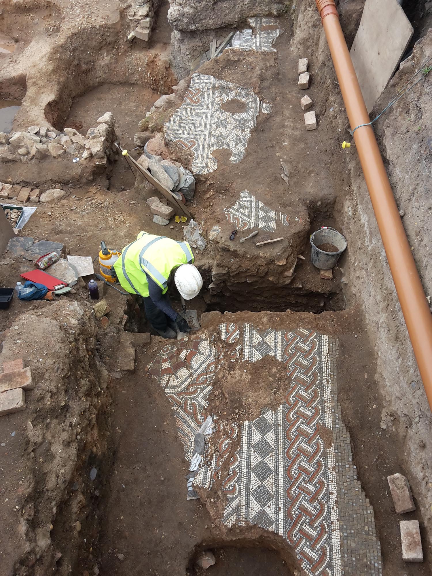 Part of an intricately decorated Roman mosaic is excavated near Vaughan Way and Highcross Street - University of Leicester Archaeological Services