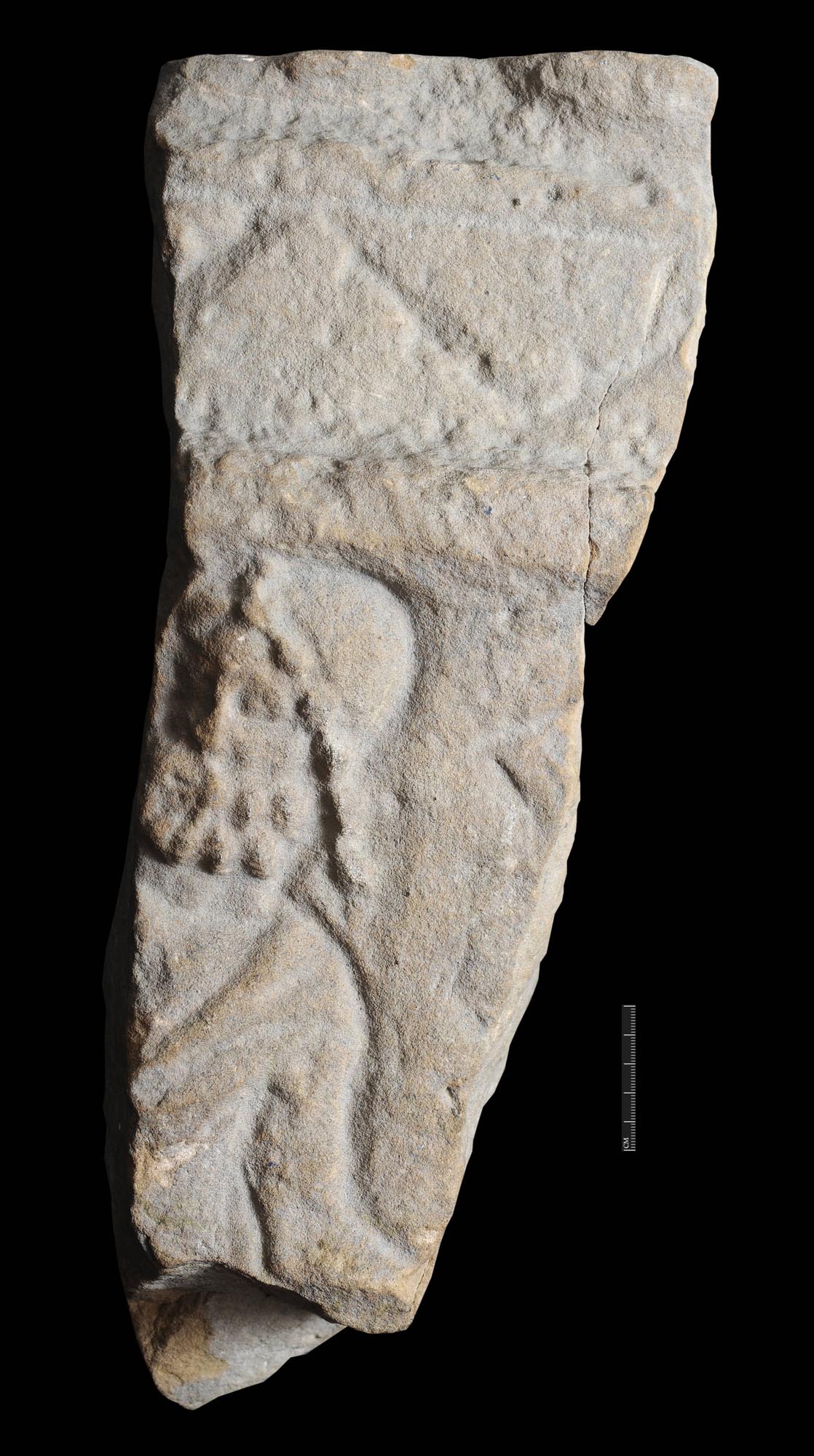 Part of an altar showing a bearded reclining figure, wearing a cap and robe. This is probably a water god like Oceanus. Found at Blue Boar Lane - University of Leicester Archaeological Services