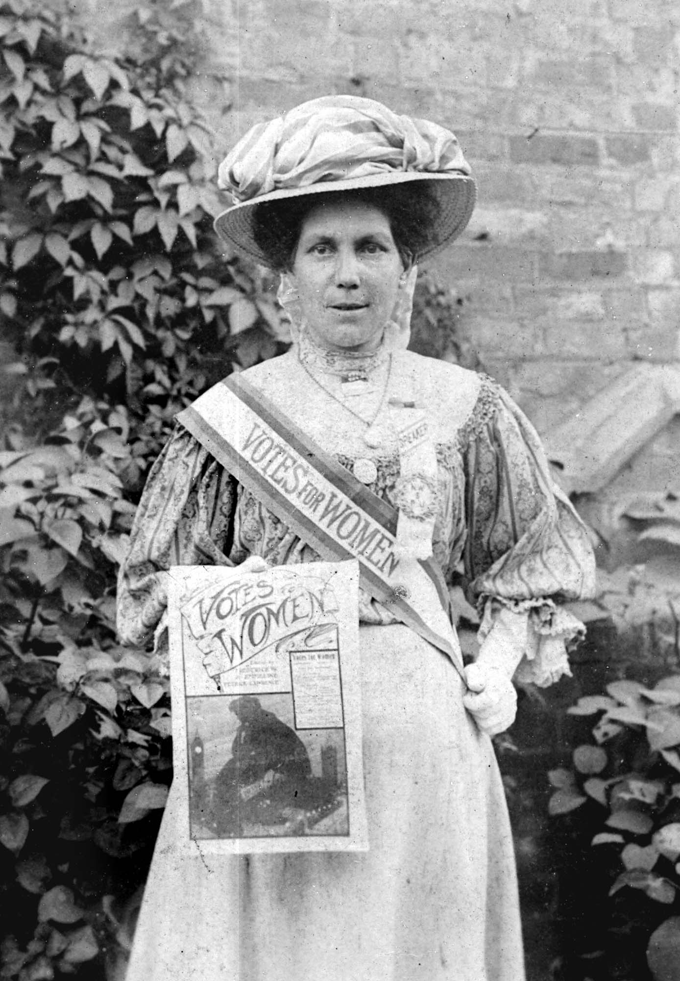 A portrait of Alice Hawkins wearing her suffrage sash and rosette - Peter Barratt