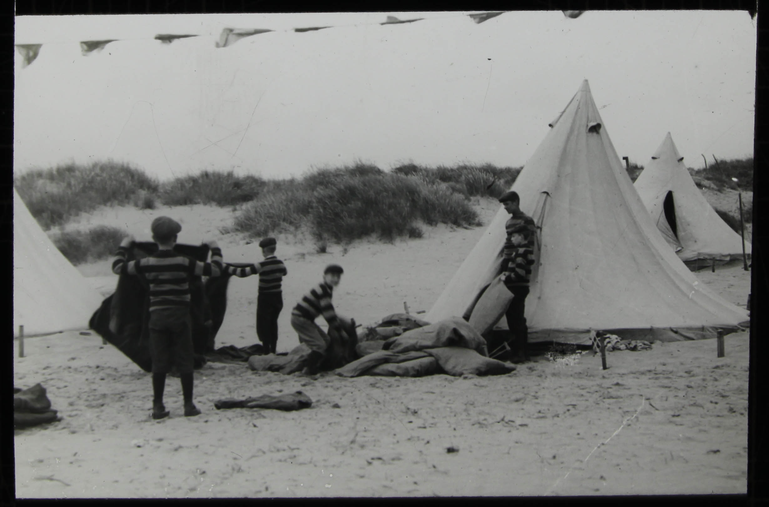 Boys pitching tents on the dunes - 