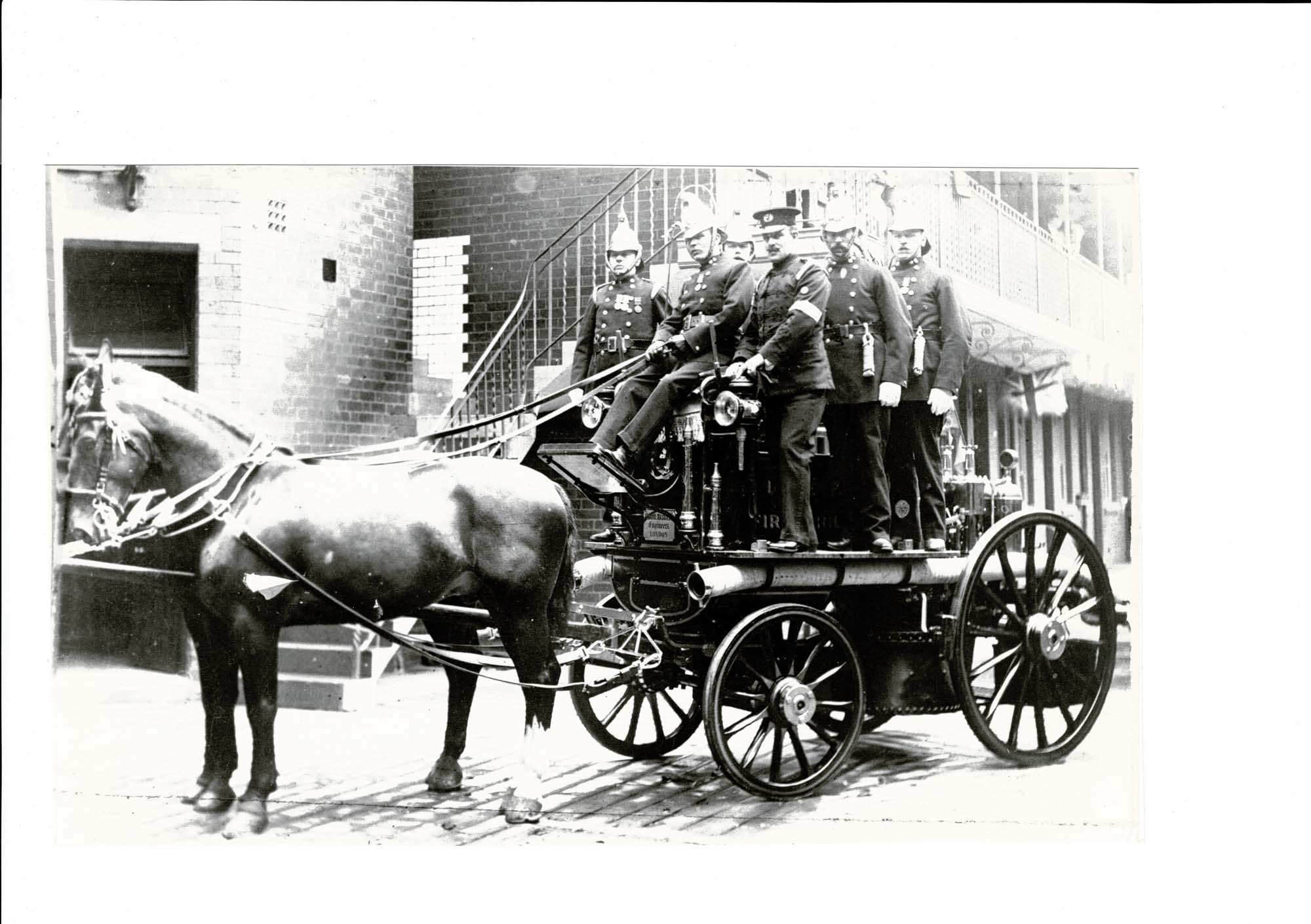 Horse-drawn fire engine. Officers wearing ceremonial brass helmets, 1890 - Malc Tovey